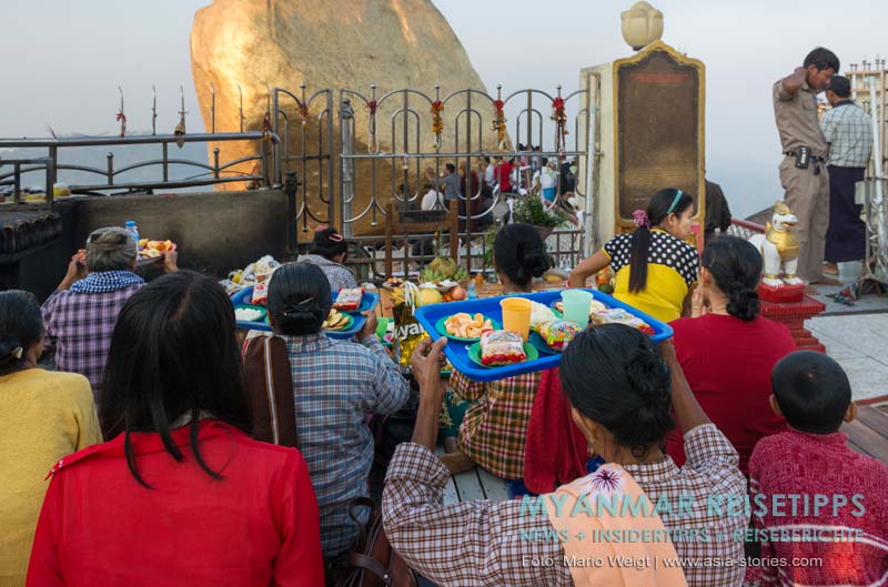 Gebete am Goldener Felsen Kyaikhtiyo. Kurz vor Sonnenaufgang füllt sich der Vorplatz vom Goldenen Felsen mit Gläubigen.