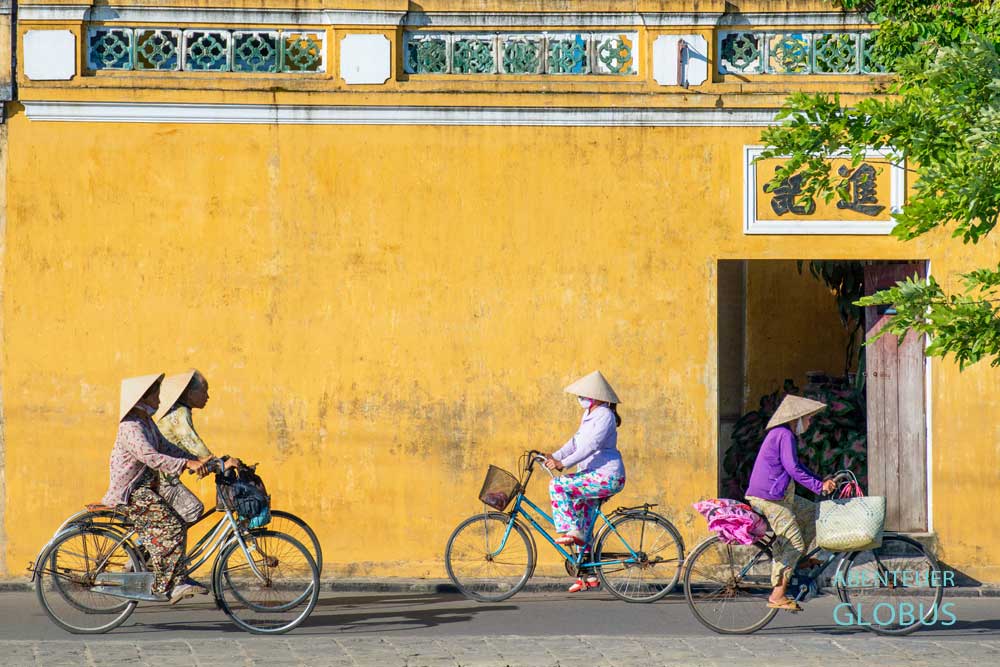 Radfahrerinnen mit Reishut in Hoi An
