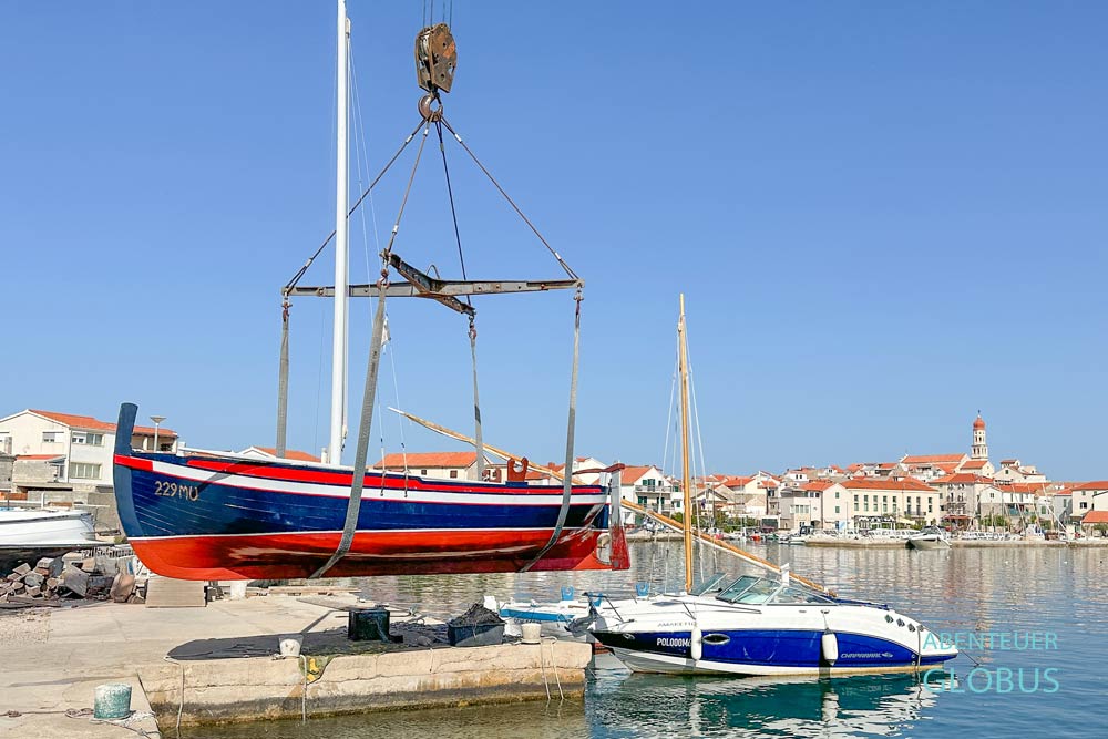 Insel Murter: traditionelles Gajeta Holzboot und Blick auf den Ort Betina