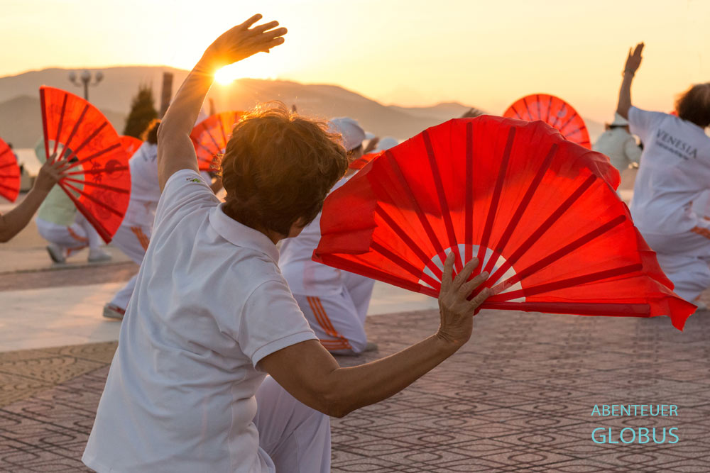Sonnenaufgang über der Insel Hon Tre und Fächertanz auf dem Platz des 2. April in Nha Trang