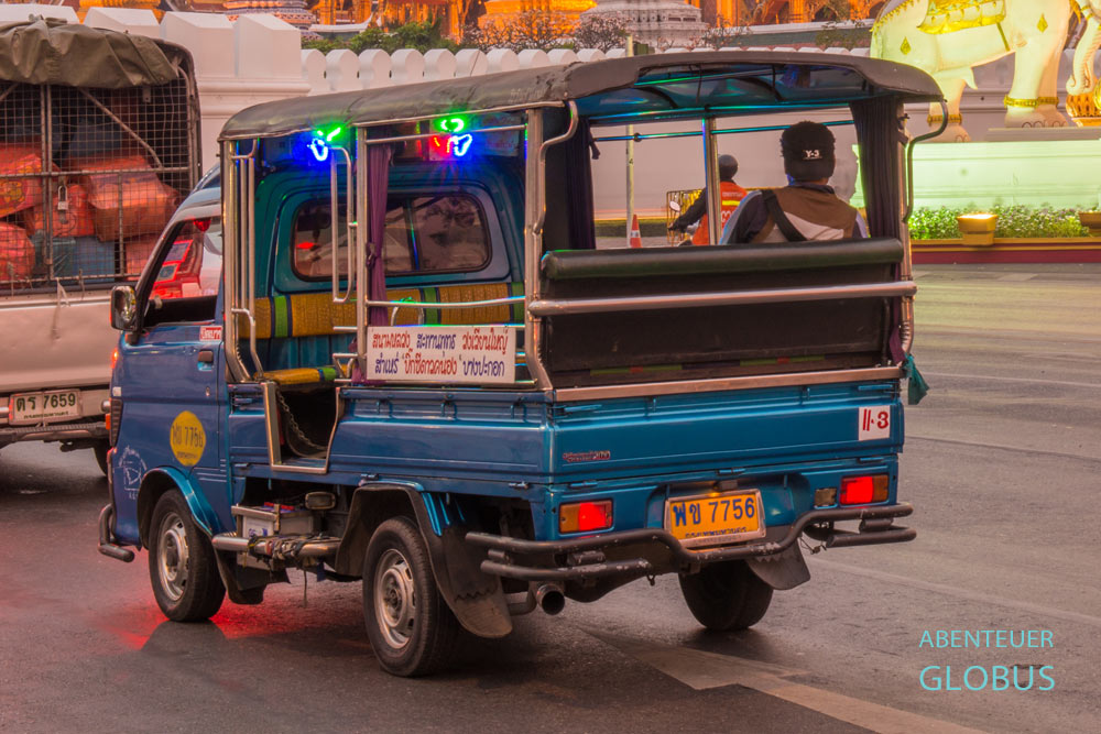 Blaues Songthaew unterwegs auf der Straße in Bangkok, Thailand