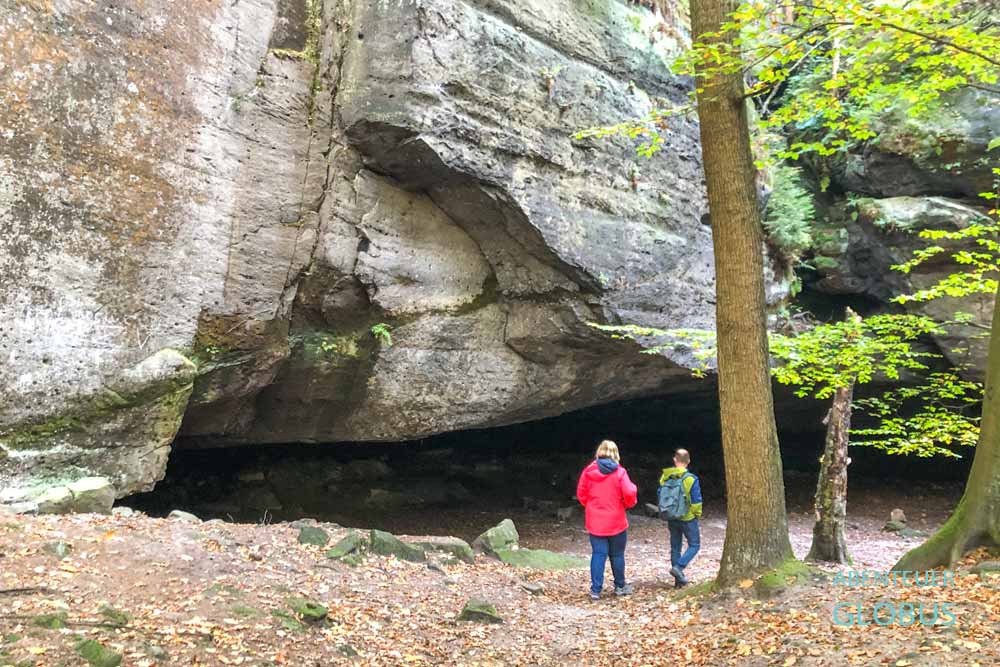 Zwei Wanderer an der Gautschgrotte am Hohnsteiner Lehrpfad Teil 2 im Hohnsteiner Wald bei Hohnstein im Nationalpark Sächsische Schweiz 
